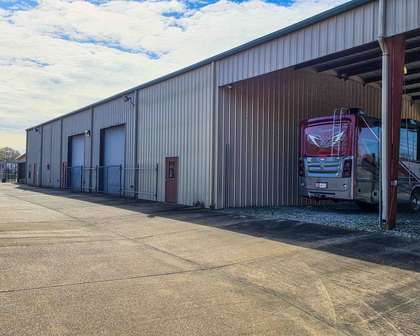 Covered RV and boat parking with a motorhome at Premier Storage & Shipping in Addis, LA