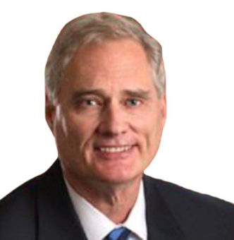Portrait of a smiling man in a dark suit and tie on a red background.