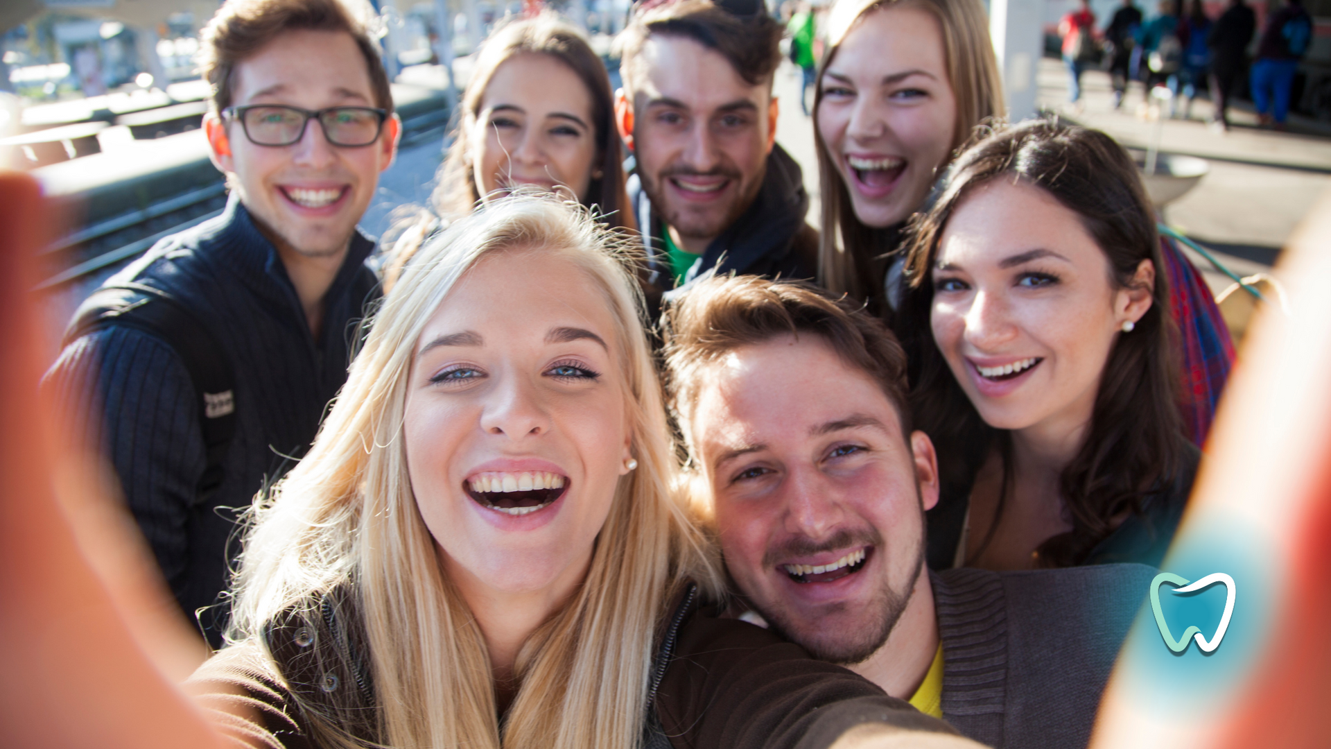 A group of young people are taking a selfie together.