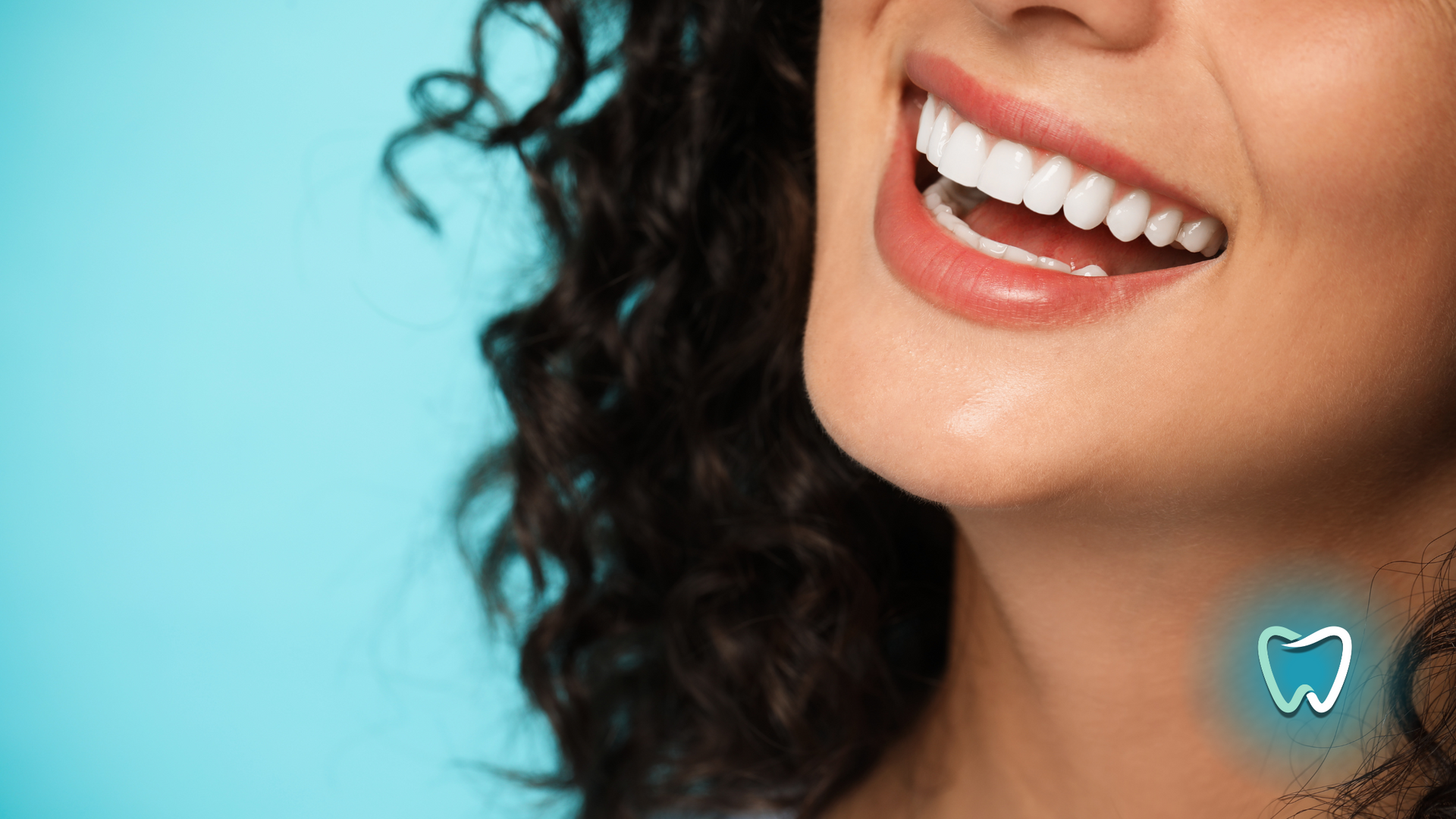 A close up of a woman 's smile with a tooth in the background.