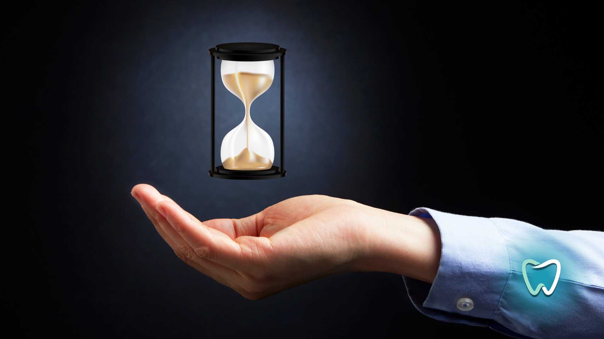 A person is holding a hourglass in their hand.