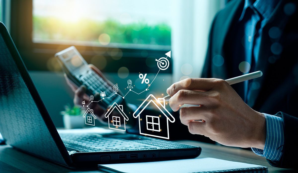 Person using a smartphone beside a laptop with digital smart home icons overlayed