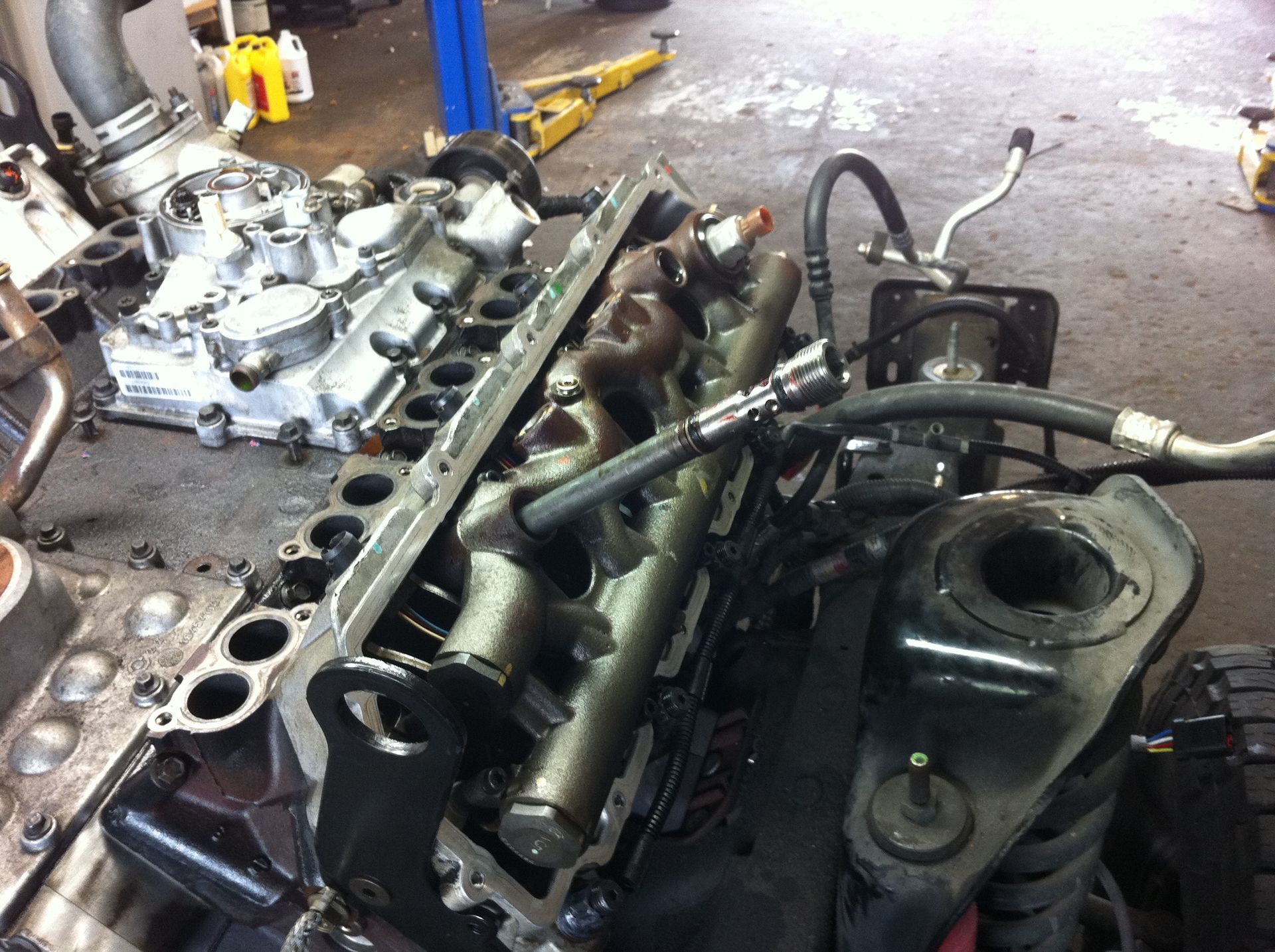A car engine is being worked on in a garage