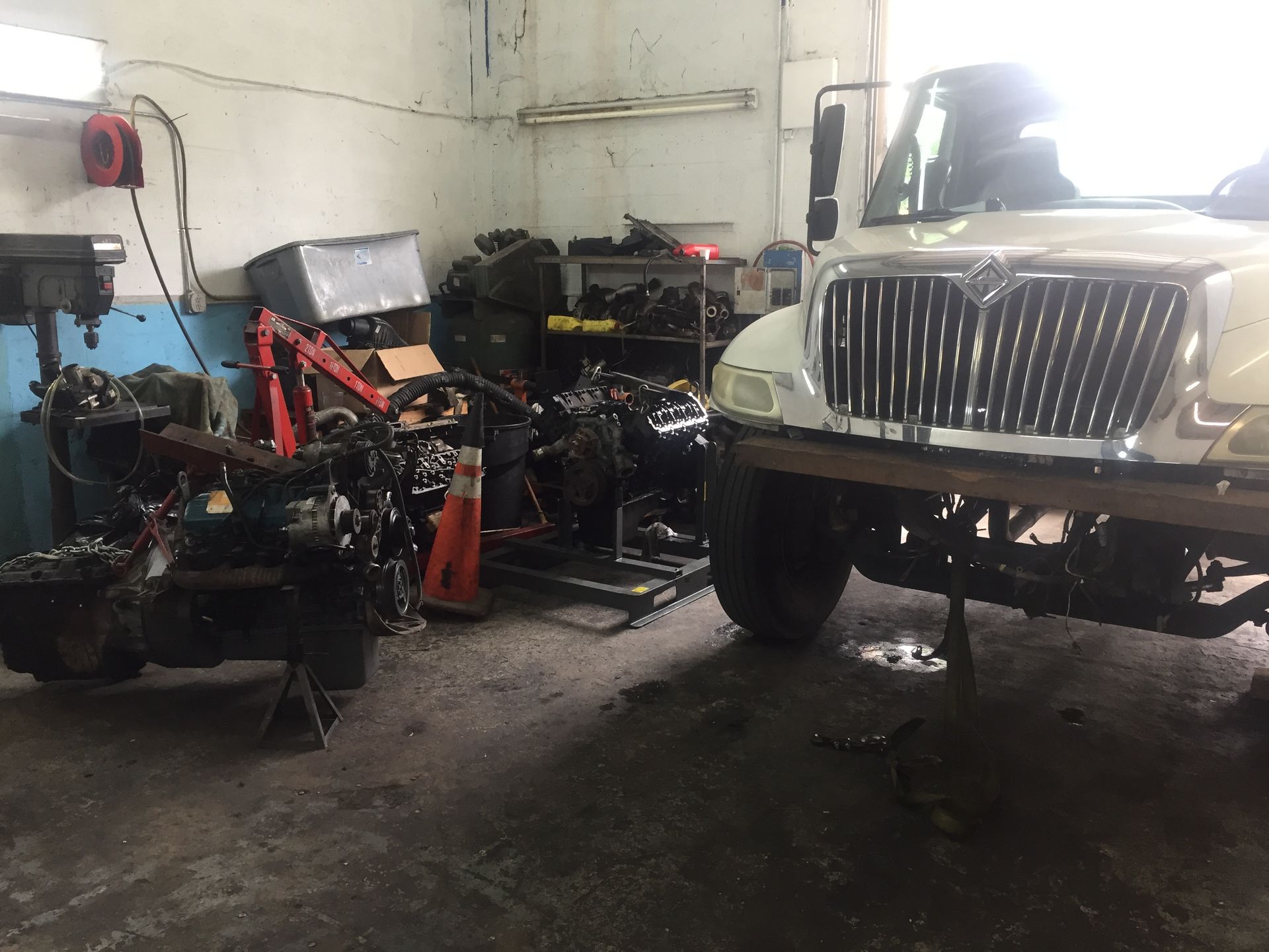 A truck is being worked on in a garage.