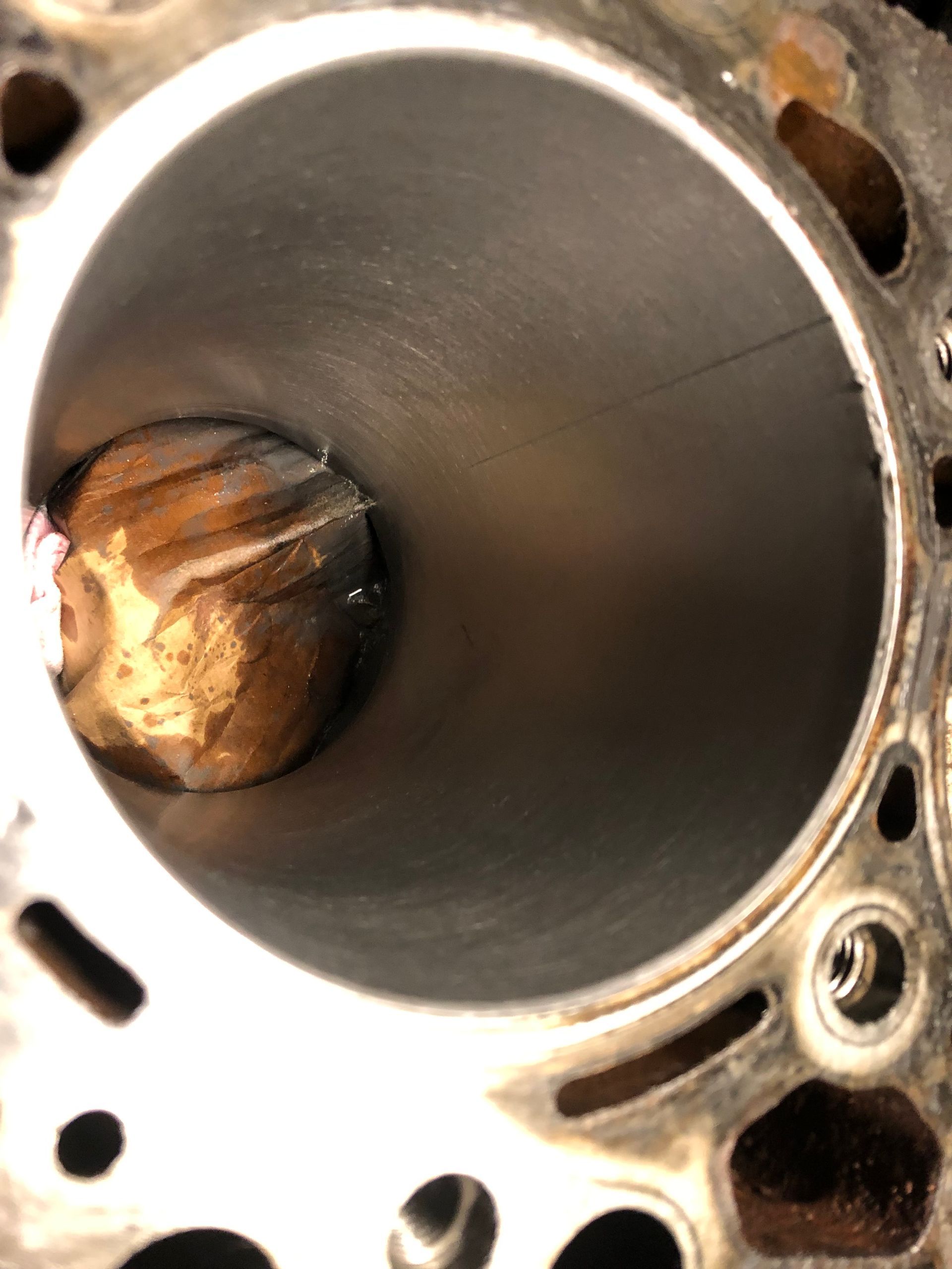 A close up of a metal cylinder with a hole in it