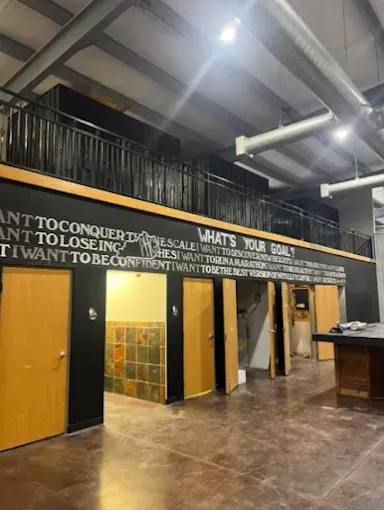 A wall with wooden doors and an inspirational 