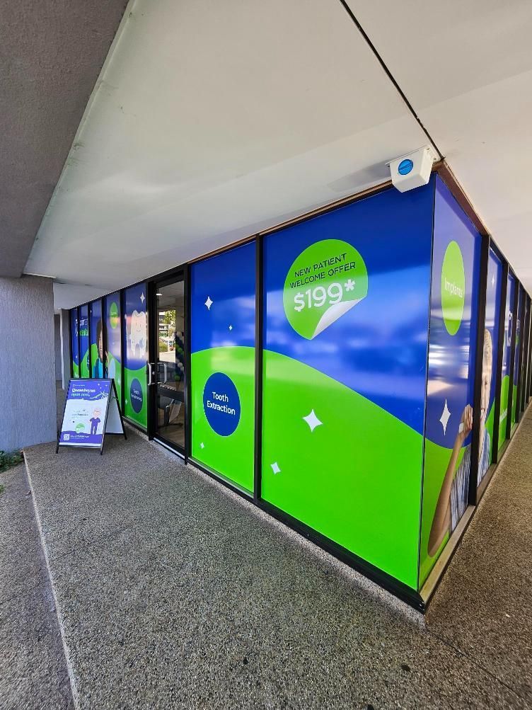 A Building With a Lot of Windows and a Sign on the Side of It — Signworld In Mitchell, ACT