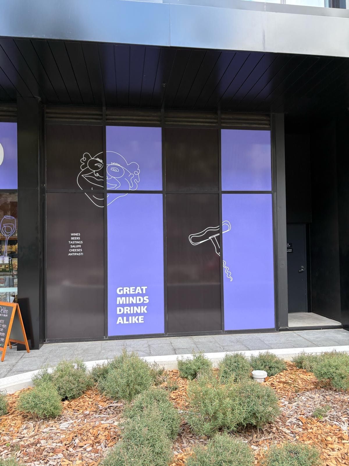 A building with a sign that says great minds drink alone — Signworld In Mitchell, ACT