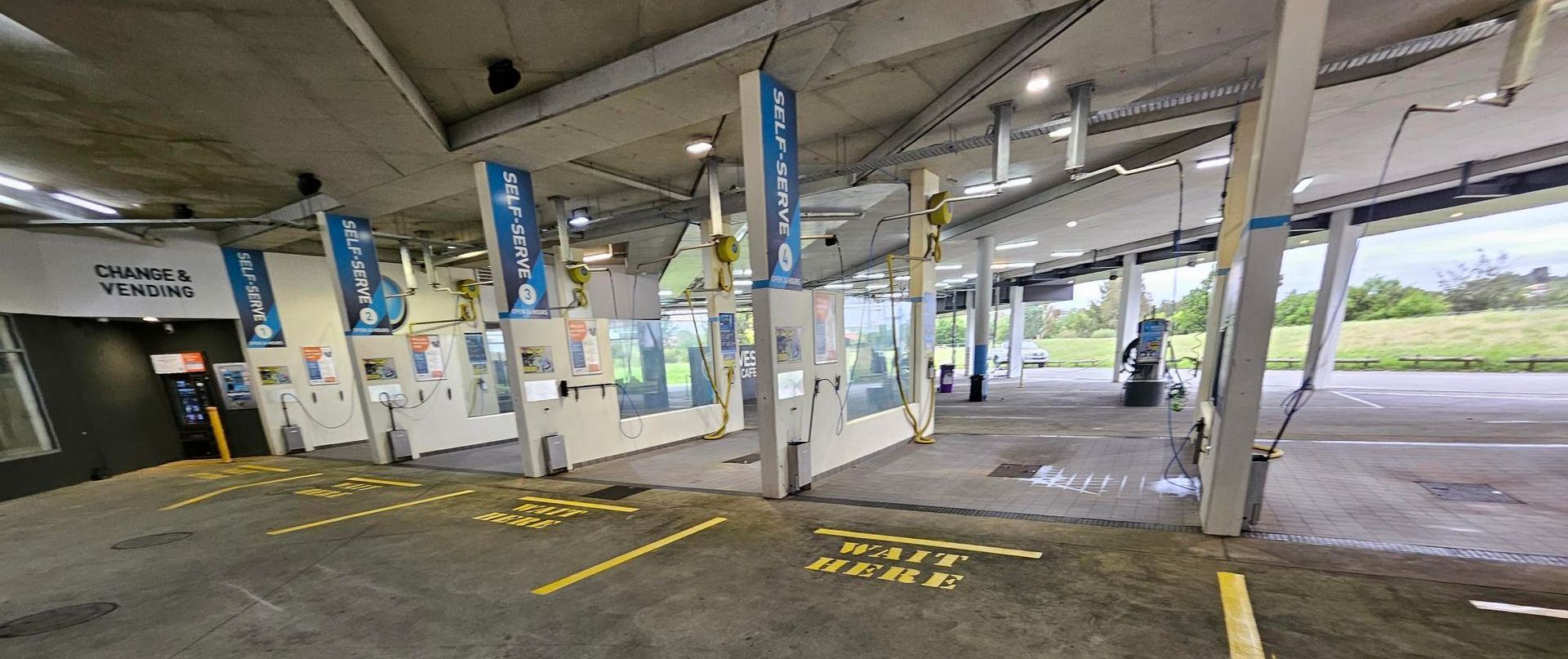 The inside of a car wash with a lot of signs on the walls — Signworld In Mitchell, ACT
