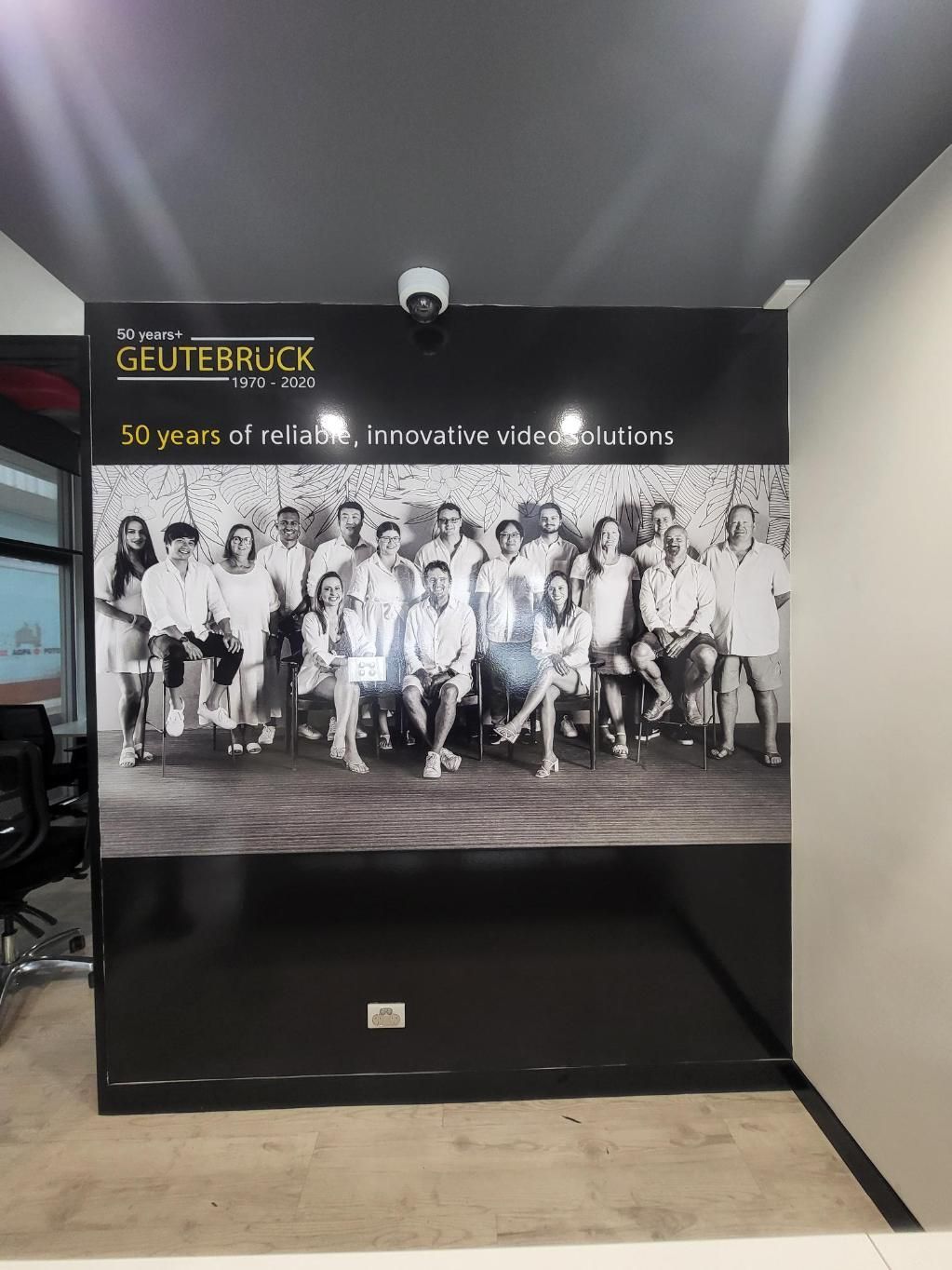 A Group of People Are Standing in Front of a Sign That Says 'Gutebruck' on It — Signworld In Mitchell, ACT