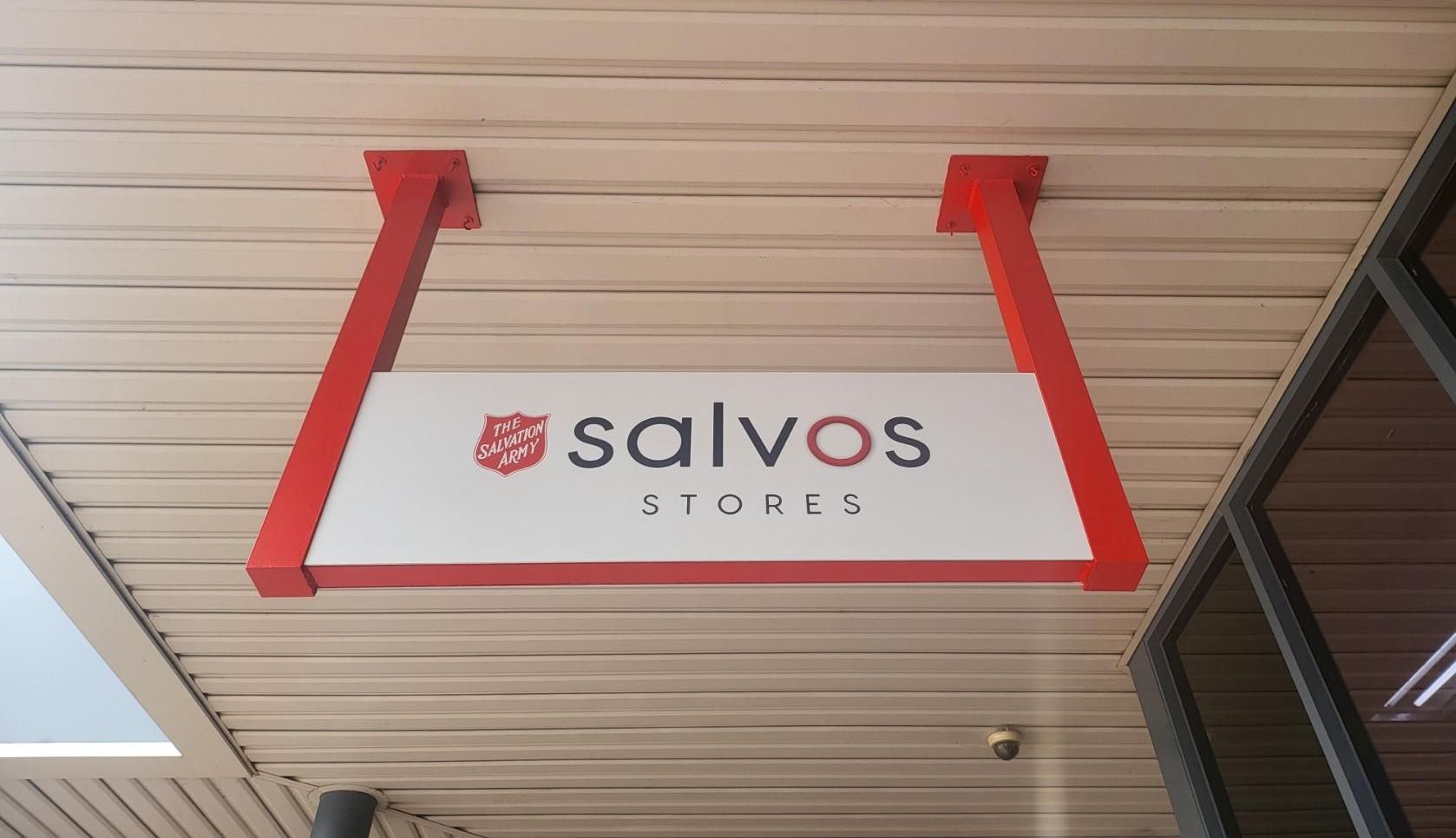 A Salvos Store Sign Hangs From the Ceiling of a Building — Signworld In Mitchell, ACT