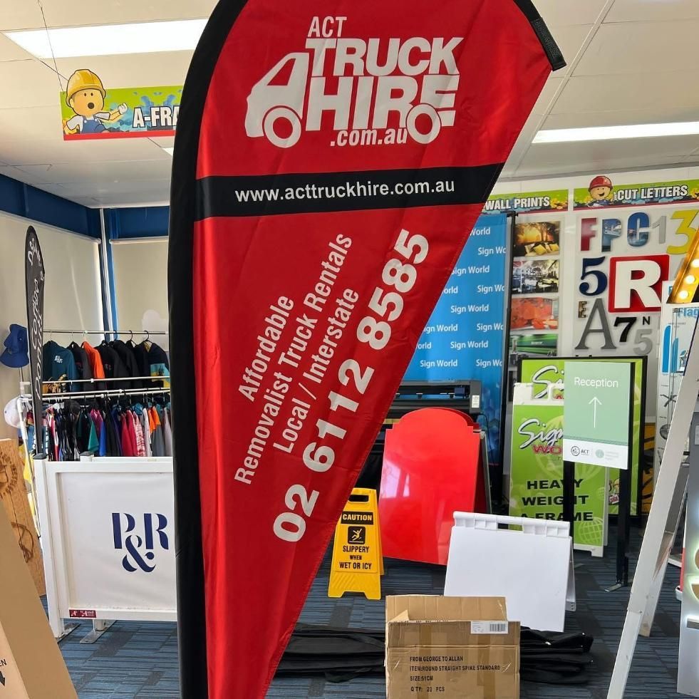 A Red and Black Flag That Says Act Truck Hire — Signworld In Mitchell, ACT