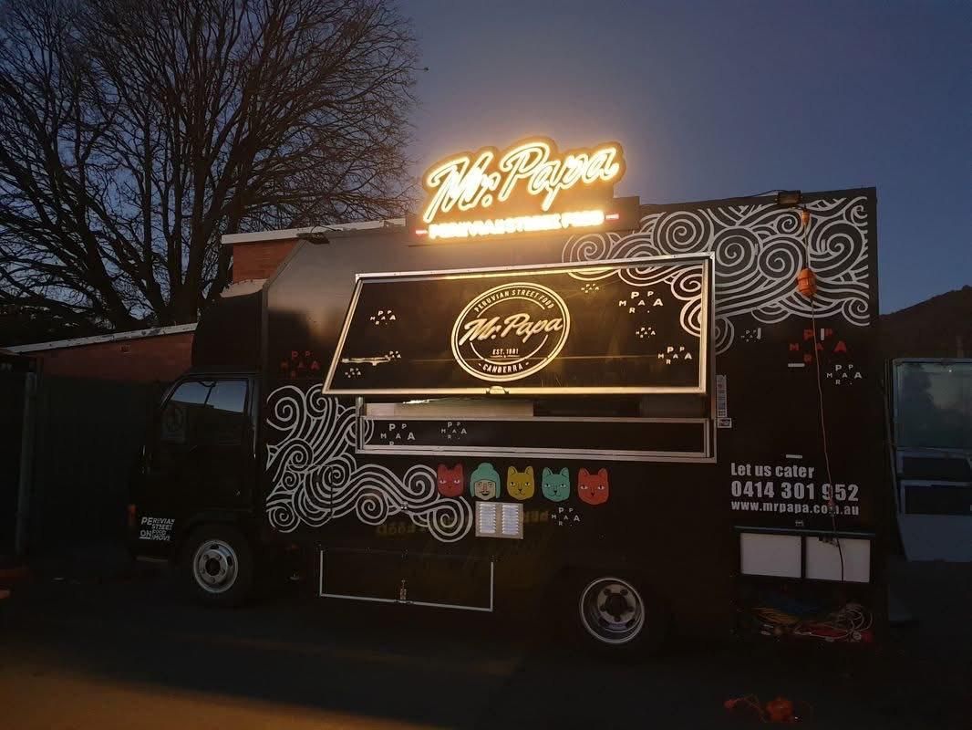 A Food Truck is Parked in Front of a Building at Night — Signworld In Mitchell, ACT