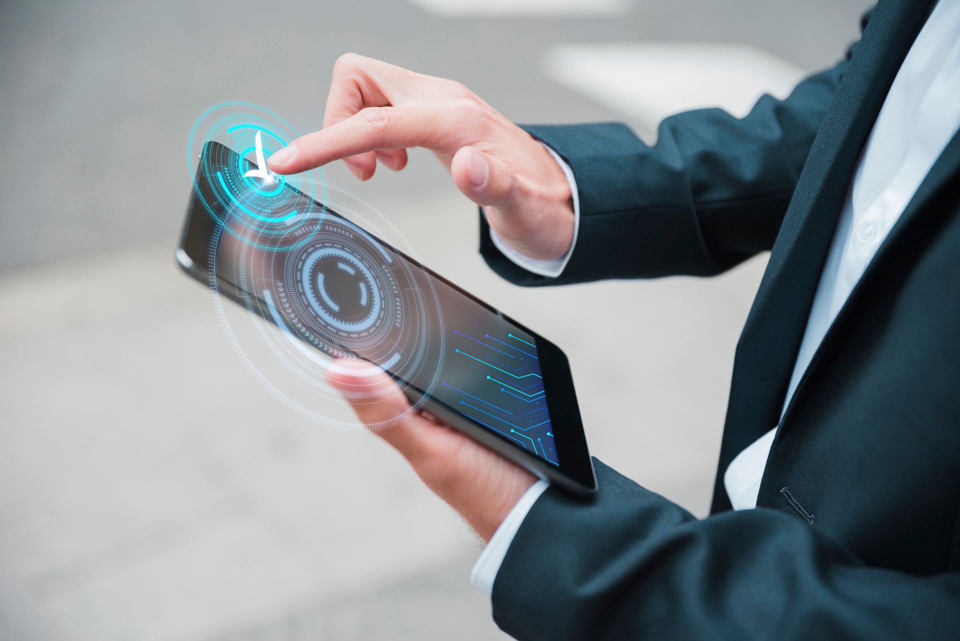 A professional in a suit interacting with a digital tablet displaying futuristic holographic interfaces, symbolizing data-driven risk management and the tracking of leading safety indicators in construction.