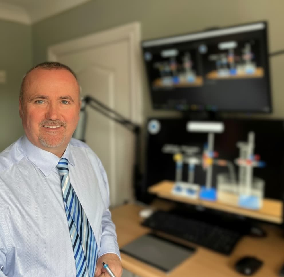 Nigel Straney, a former A-Level Chemistry examiner, in his office with his online teaching setup.
