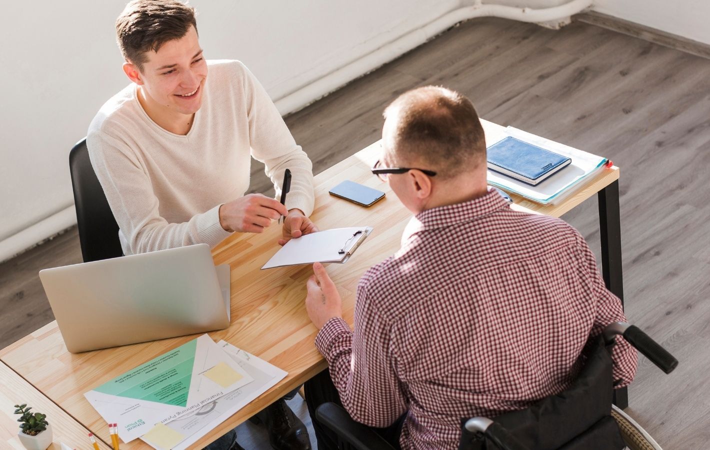 Support Worker helps NDIS Participant to understand plan.