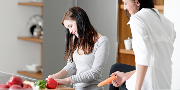 Two women prepping food in the kitchen