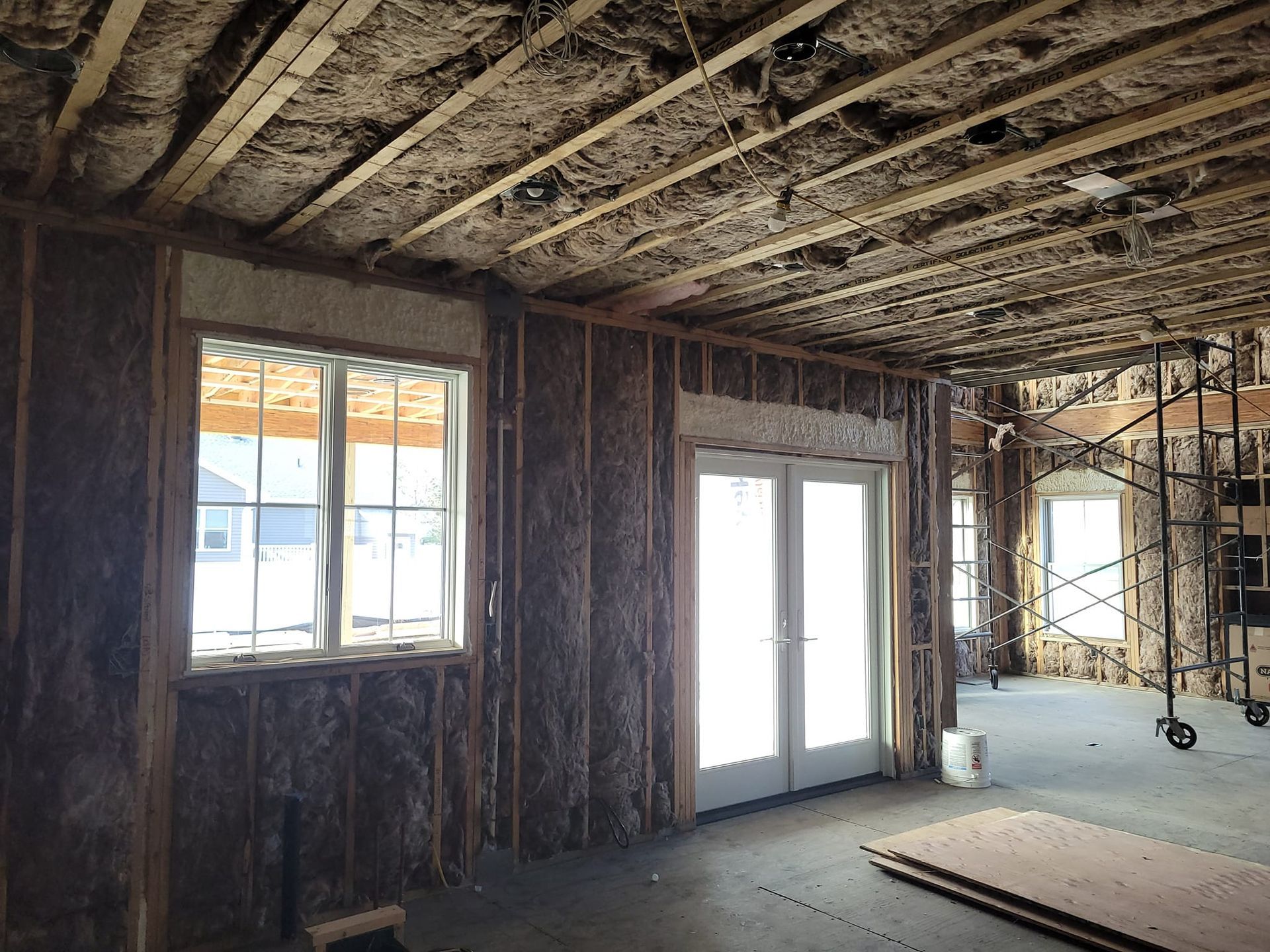 A room with a lot of windows and sliding glass doors.