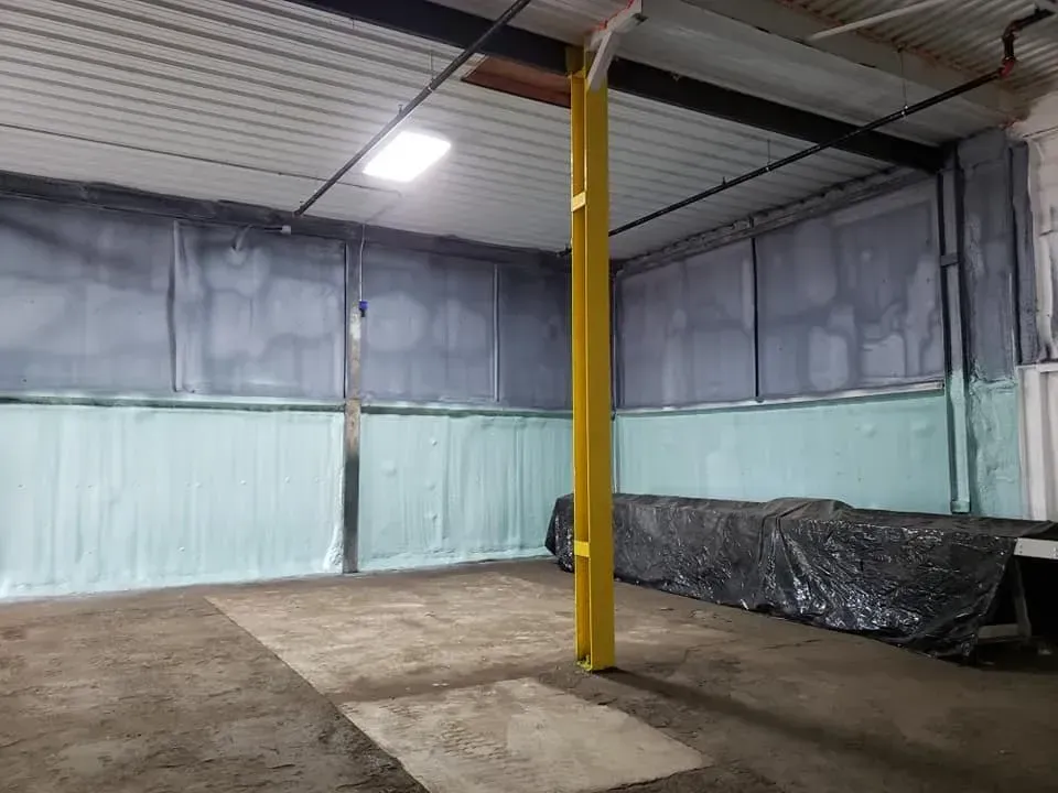 A room with a yellow pole in the middle of it.