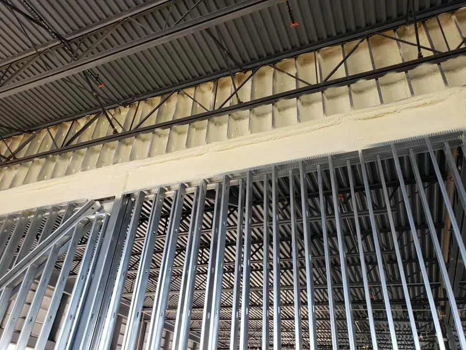 A building under construction with a lot of metal beams.