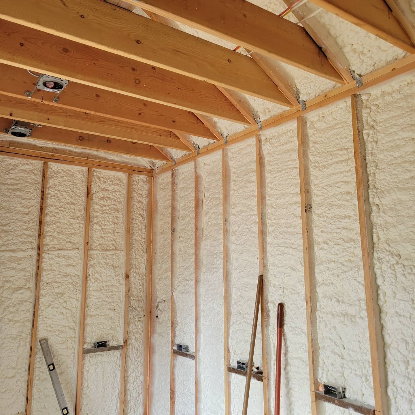 A room with wooden beams and white foam on the walls