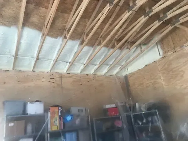 A room with a ceiling that is covered in spray foam.