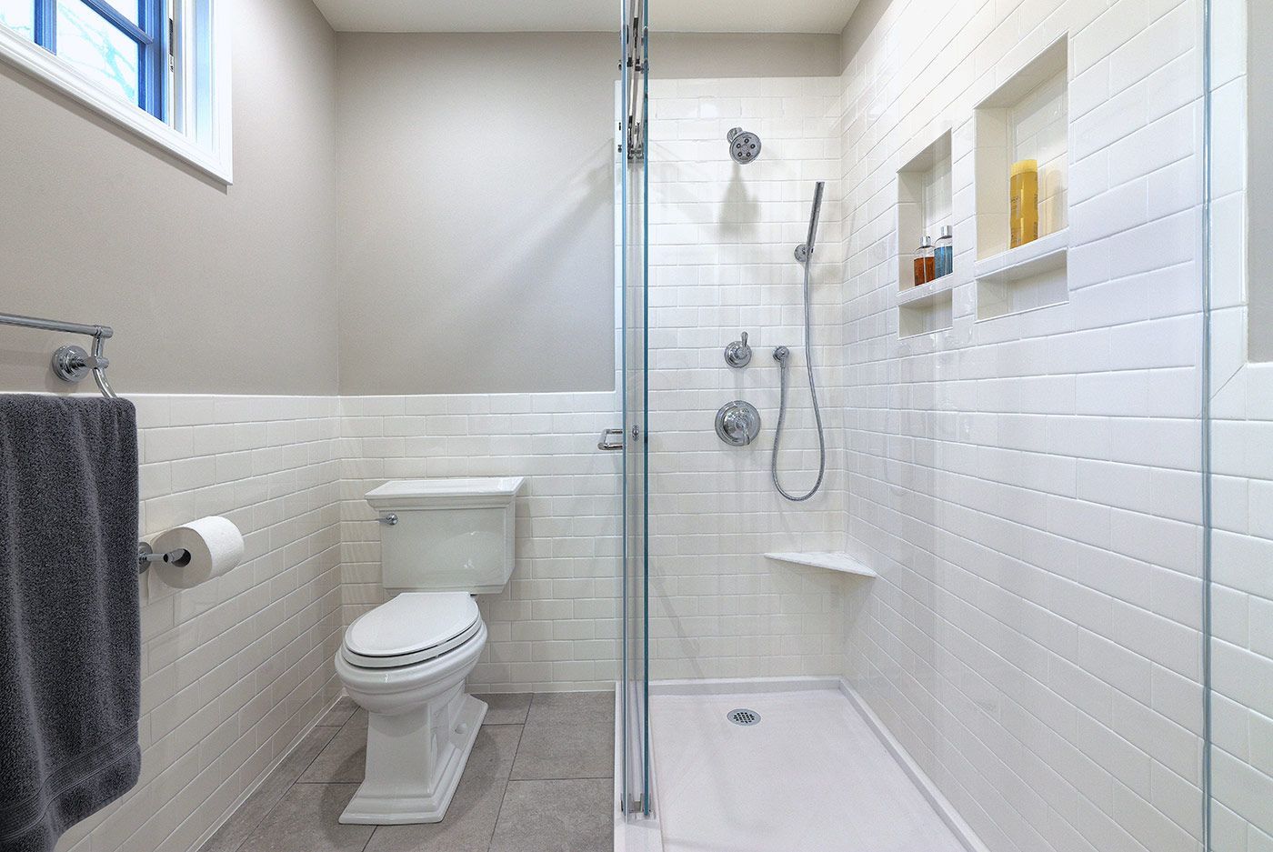 Remodeled bathroom with toilet and shower by Gartman Remodeling in Kansas City