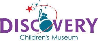 Discovery Children's Museum logo in purple and teal with a stylized child in a globe and stars above