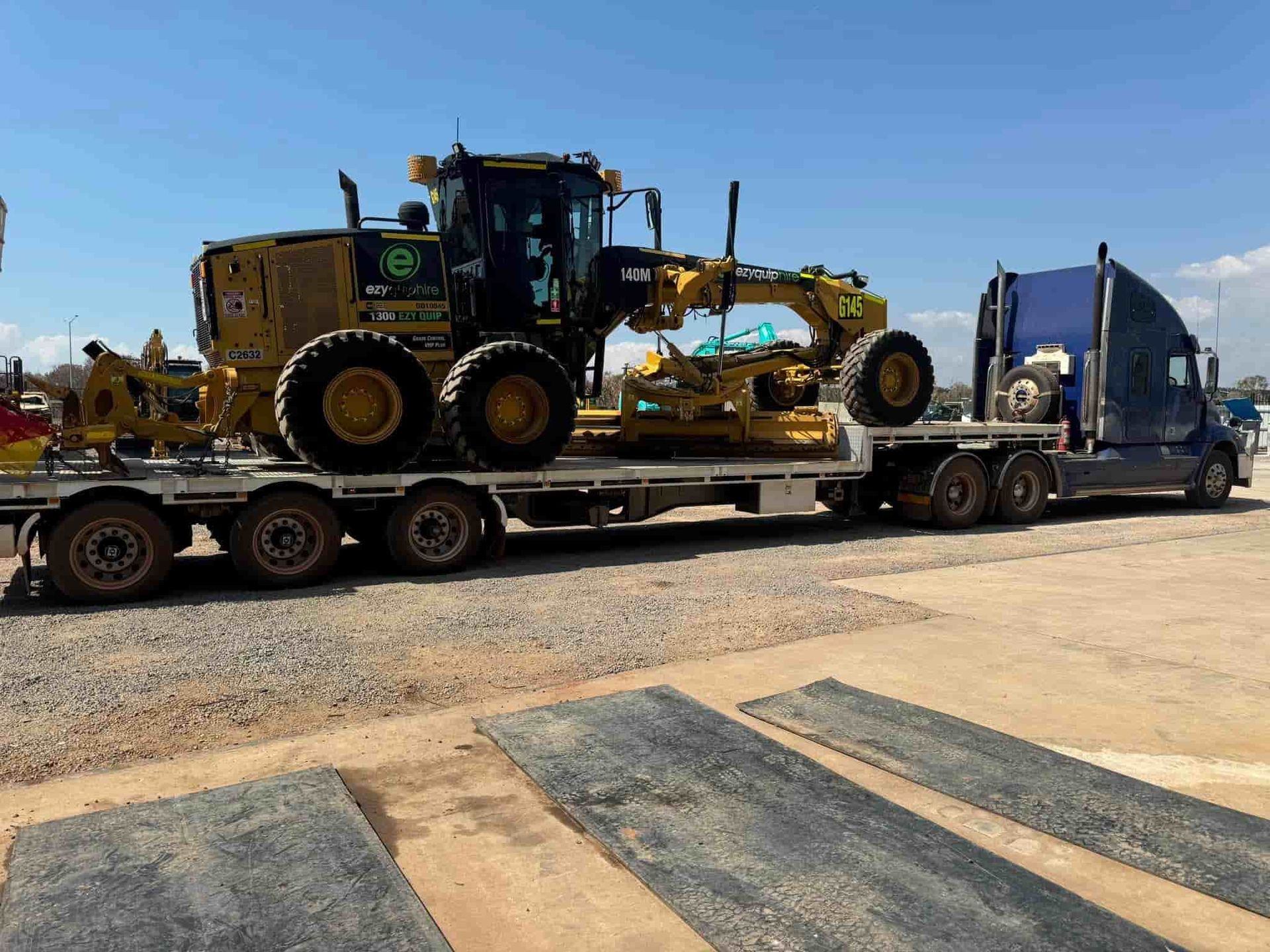 A Truck is Carrying a Bulldozer on a Flatbed Trailer — Cohen’s Towing & 4WD Recoveries In Winnellie, NT