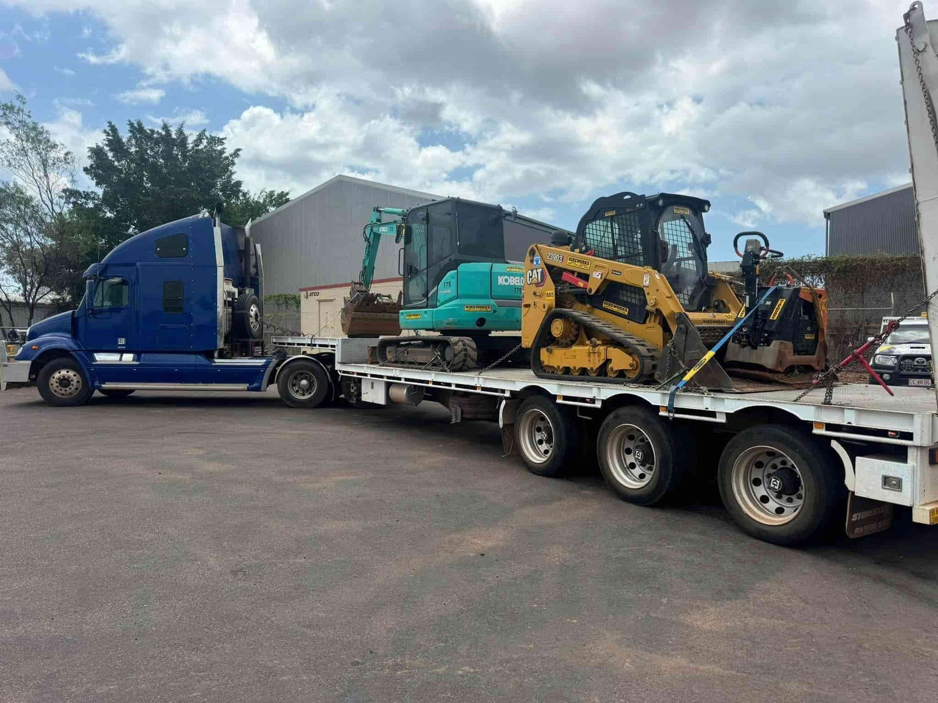 A Semi Truck is Carrying a Bulldozer on a Flatbed Trailer — Cohen’s Towing & 4WD Recoveries In Winnellie, NT