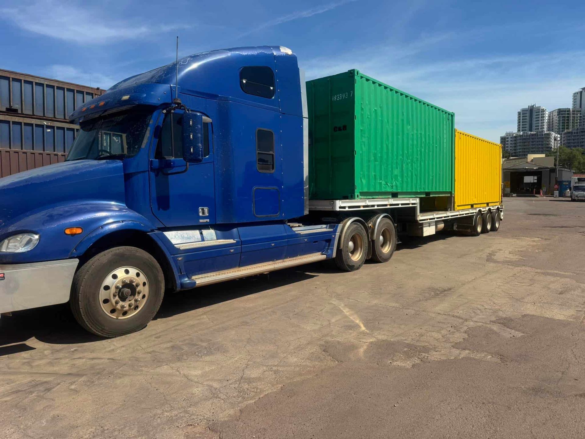 A Blue Semi Truck is Carrying Three Shipping Containers on a Trailer — Cohen’s Towing & 4WD Recoveries In Winnellie, NT