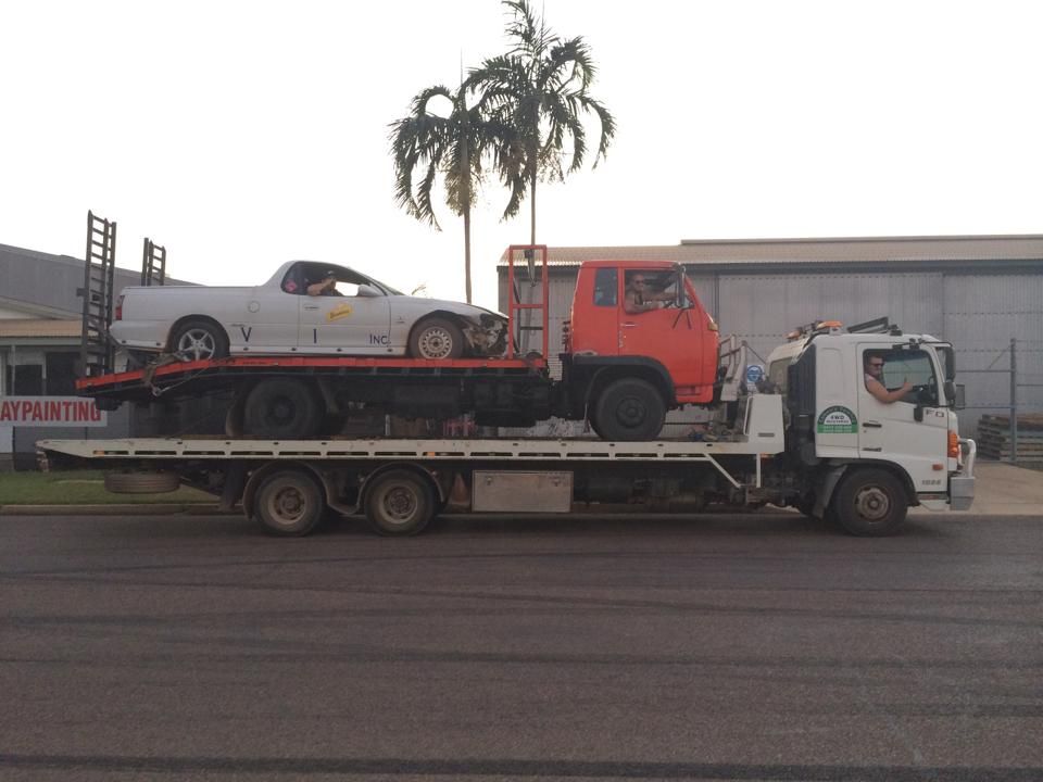 A Red Truck and white Car is on the Back of a Tow Truck — Cohen’s Towing & 4WD Recoveries In Alice Springs, NT