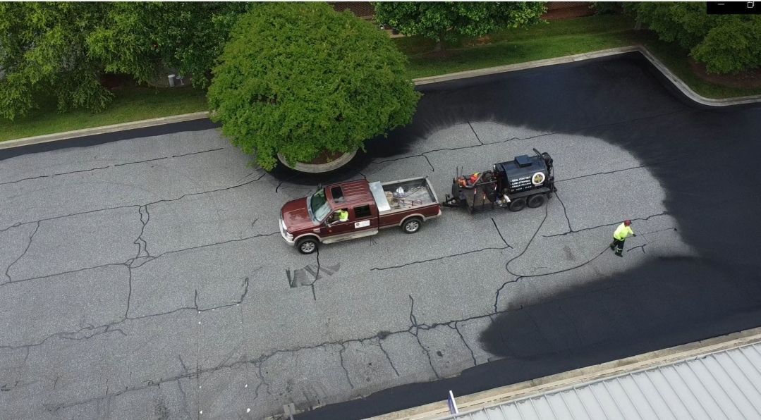 An aerial view of a parking lot being paved.