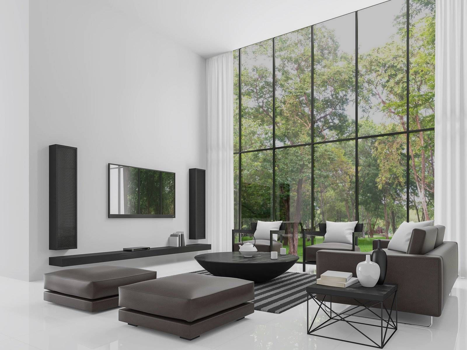 A living room with a lot of windows and furniture