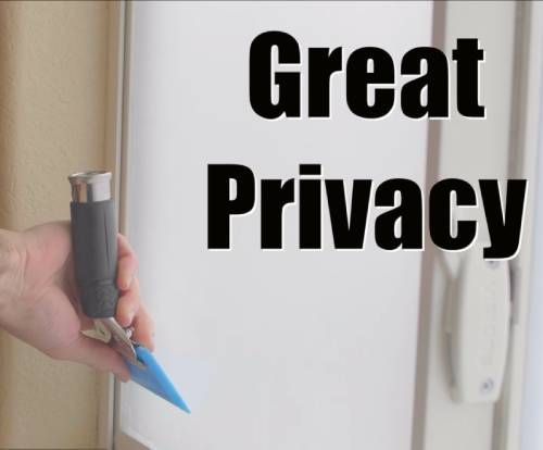 A person holding a tool in front of a sign that says great privacy