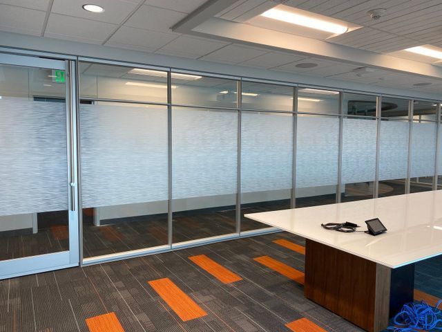 A conference room with a table and a phone on it
