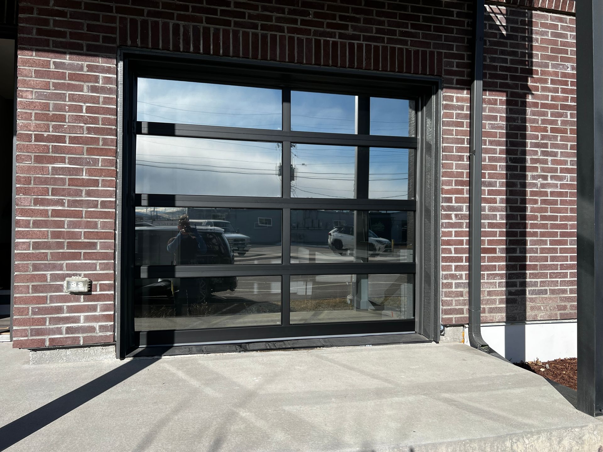A brick building with a large glass garage door