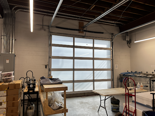 A garage with a large garage door and a table.
