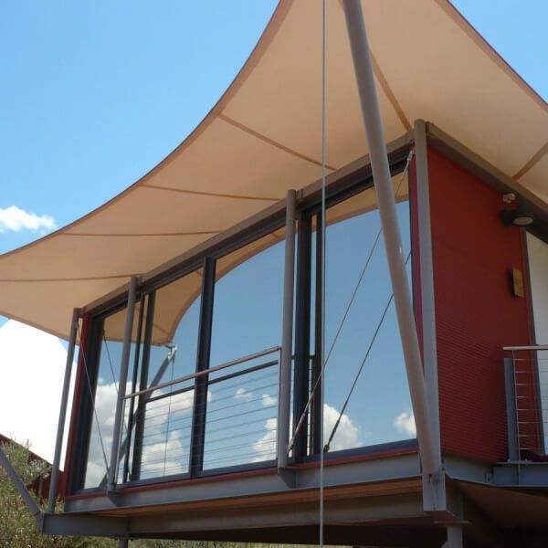 A red building with a white umbrella on top of it