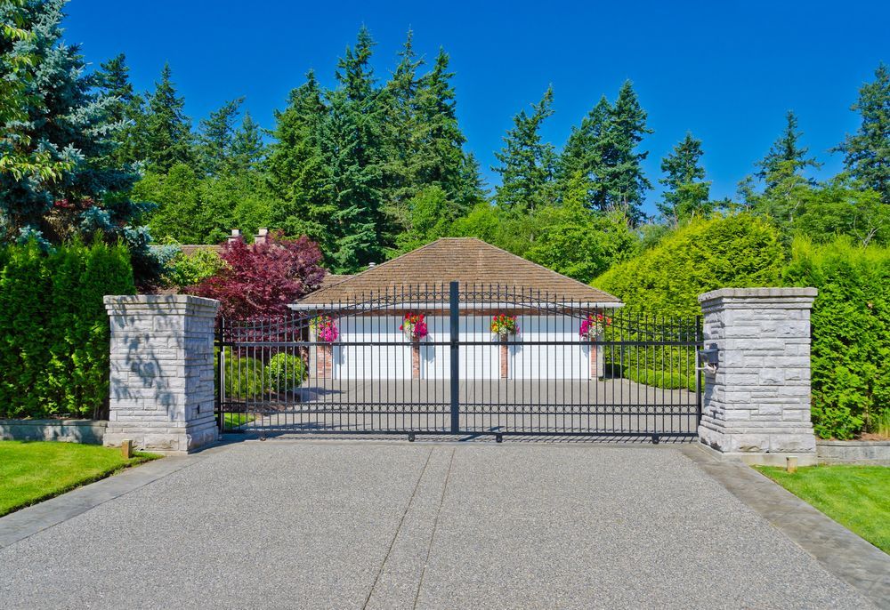 Stone Pillars With Black Gates Open to a Driveway Leading to a Garage — G.N Painting and Decorating in Lake Cathie, NSW