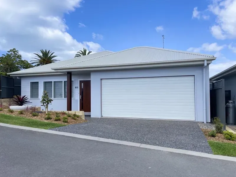Light Blue House With a White Garage Door on a Sunny Day — G.N Painting and Decorating in Port Macquarie, NSW