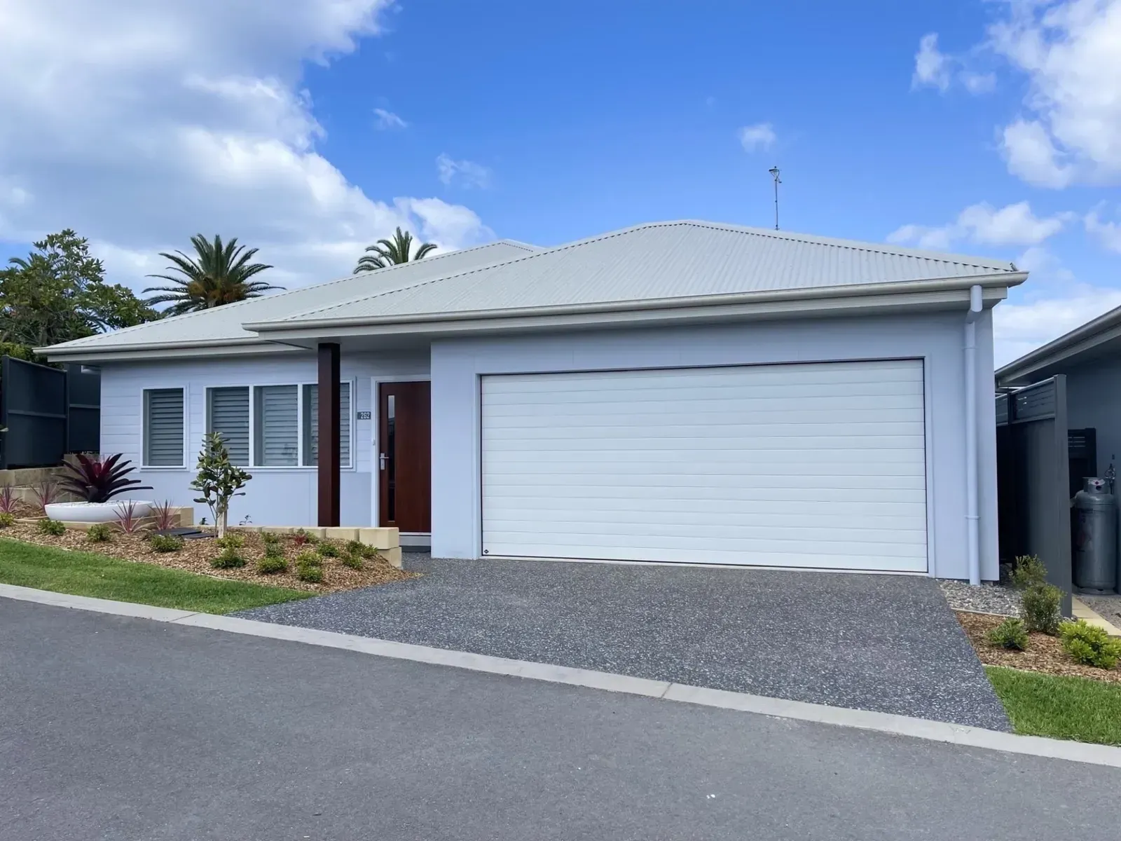 Light Blue House With White Garage Door — G.N Painting and Decorating in Port Macquarie, NSW