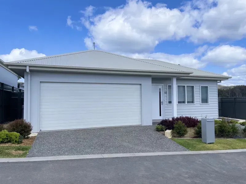 Light Blue House With White Garage Door and Gray Gravel Driveway — G.N Painting and Decorating in Port Macquarie, NSW