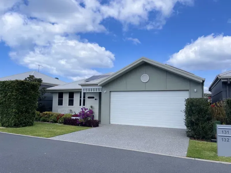 Gray House With White Garage Door, Small Front Lawn, and Blue Sky — G.N Painting and Decorating in Port Macquarie, NSW