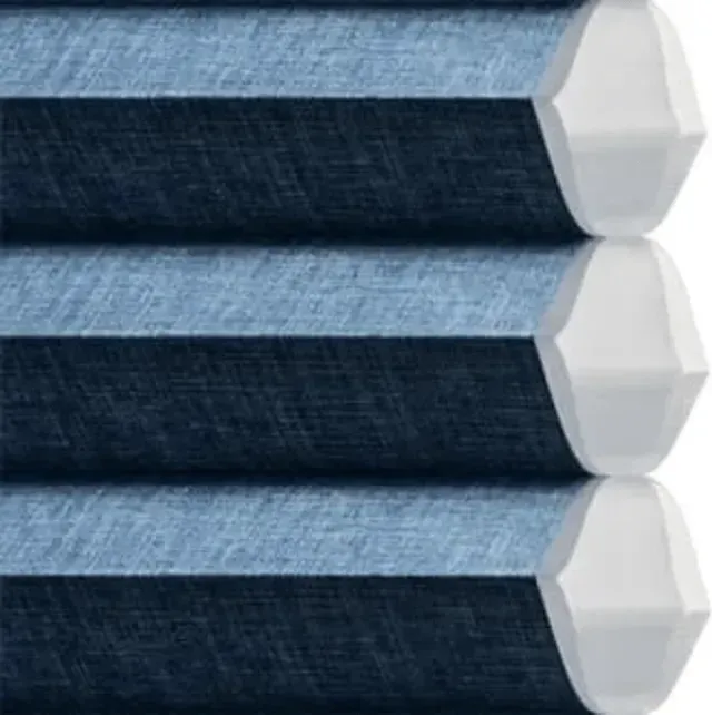 Blue honeycomb cellular shades with white end caps, detail view.
