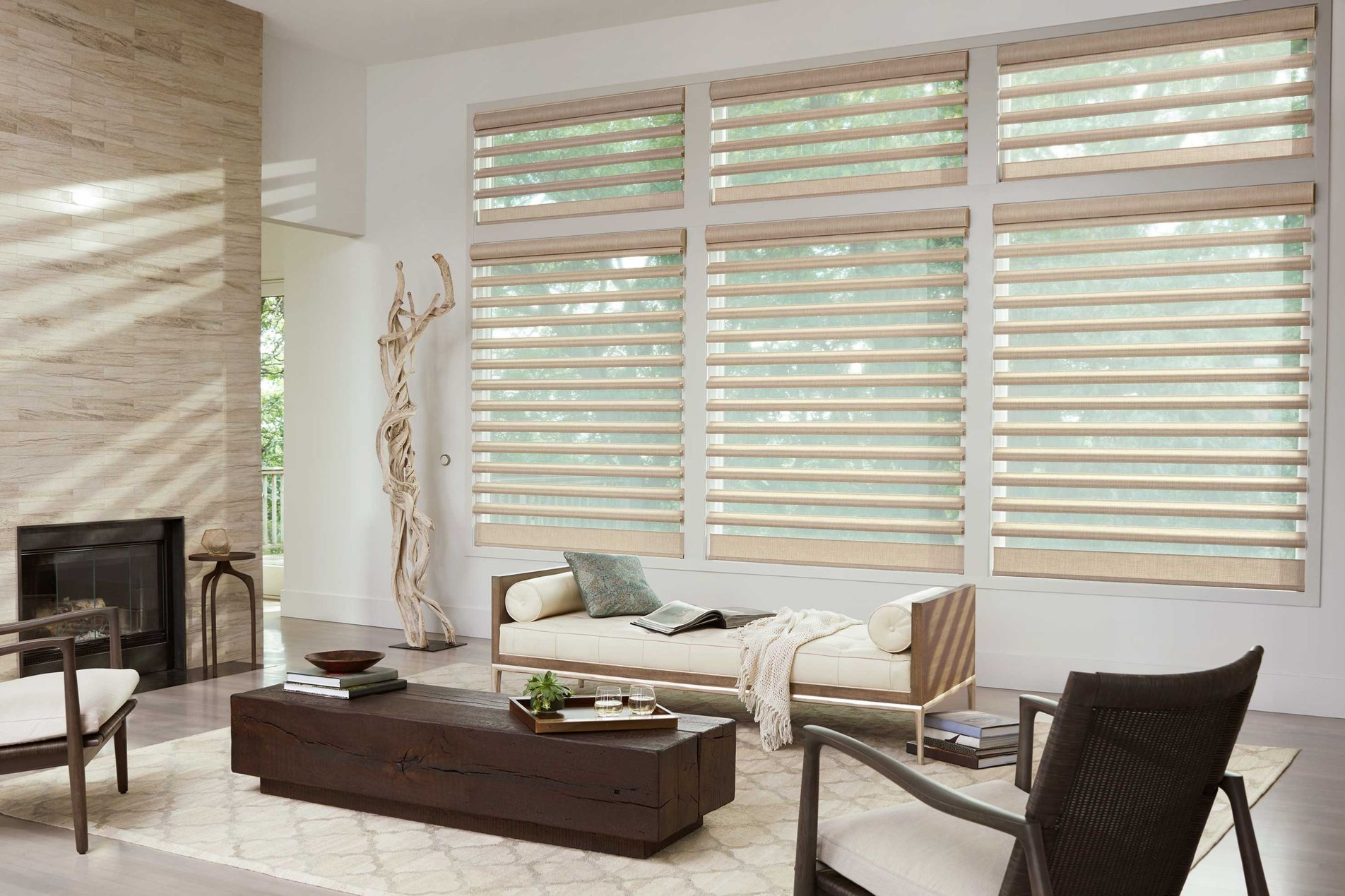 Living room with large windows, light-colored layered blinds, and modern furniture.