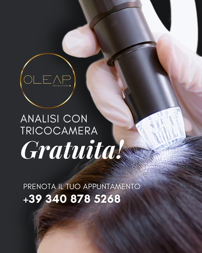 Contagocce di siero per capelli su una chioma castana lucente, accanto a una boccetta e a un fiore bianco