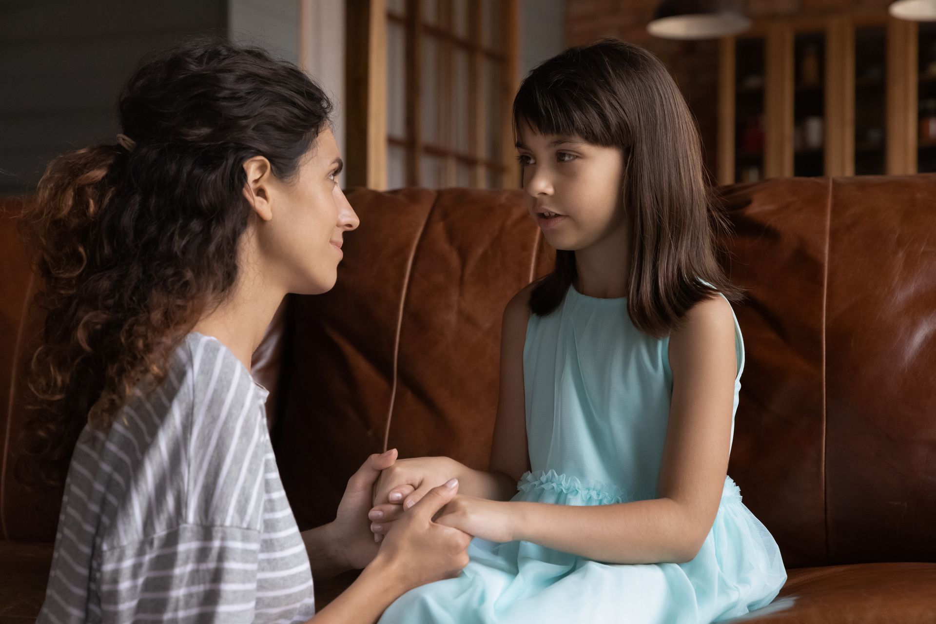 A man and a little girl are sitting on a couch.