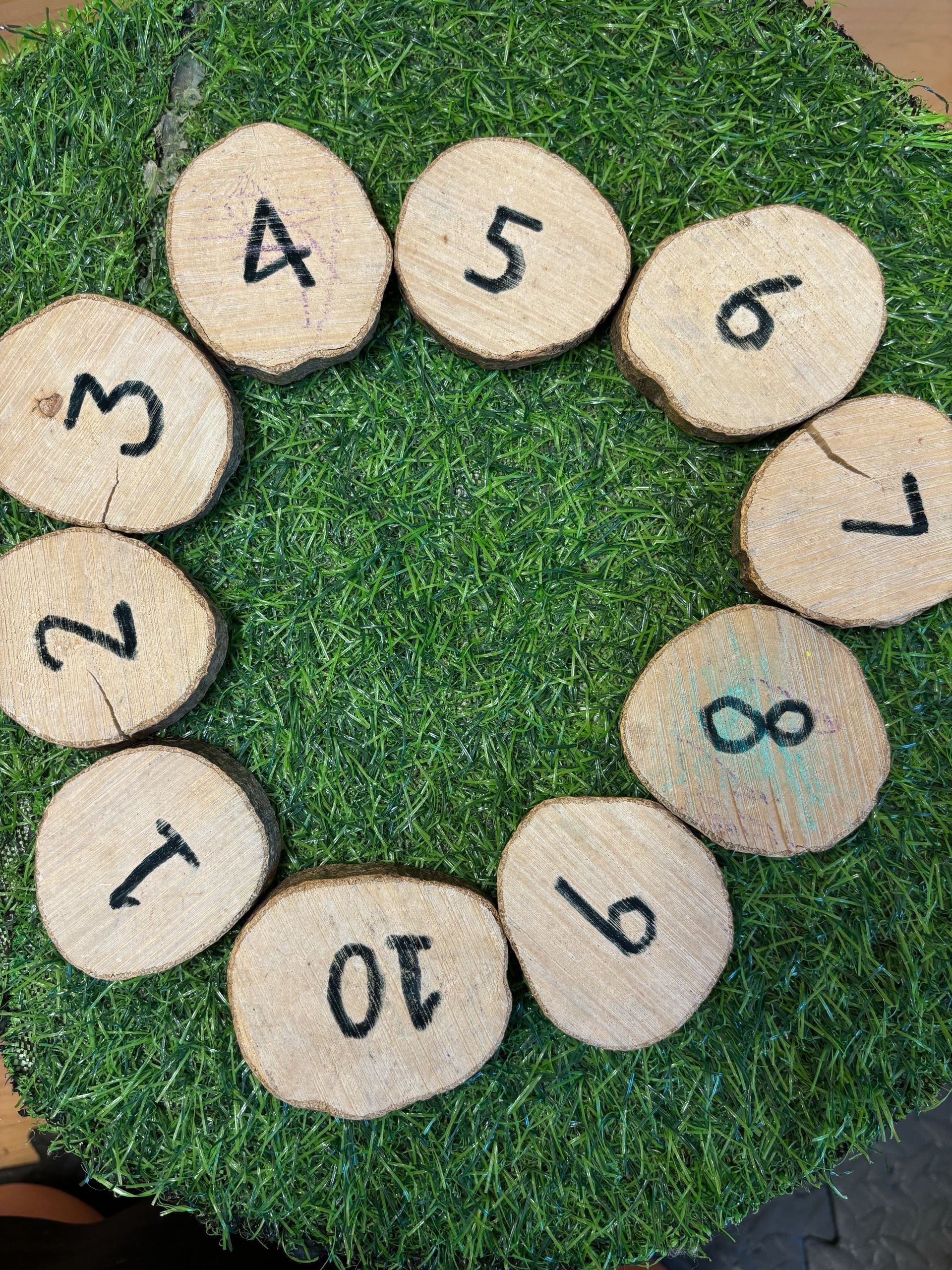 A circle of wooden slices with numbers on them