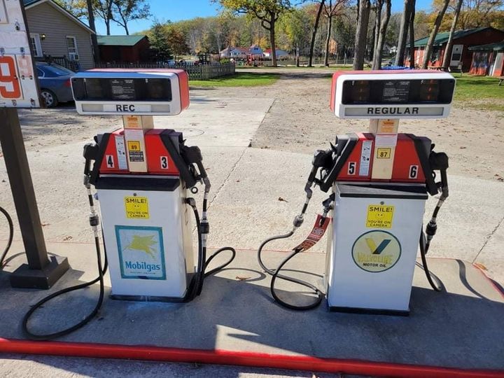 Two vintage gas pumps, labeled